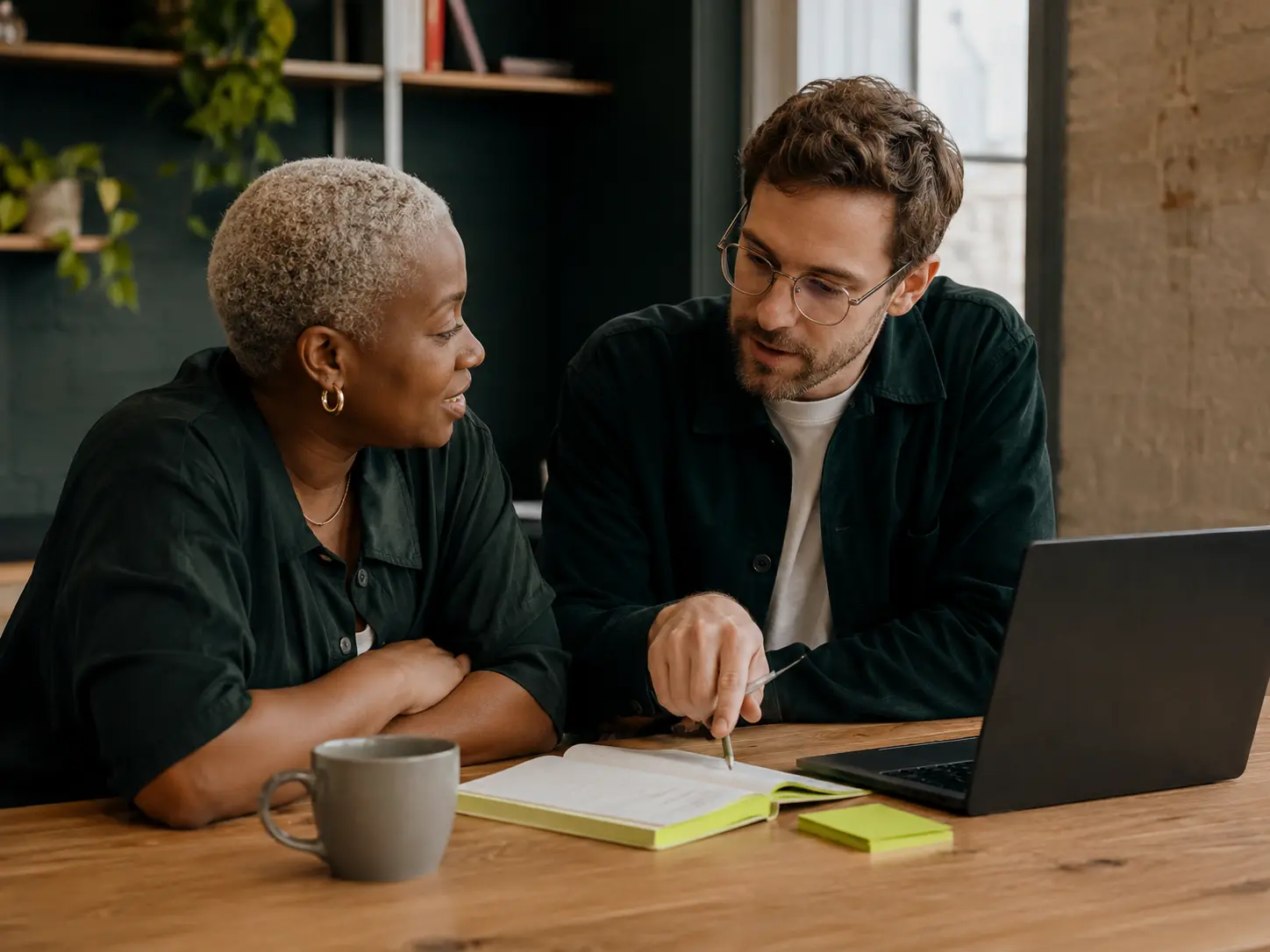 Two small business colleagues working through a practical AI plan together